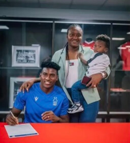 Taiwo Jesudun and Taiwo Awoniyi with their son while signing for Nottingham Forest club.